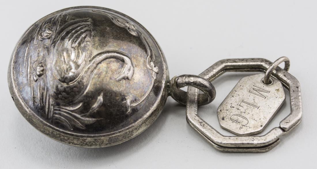 Tiffany & Co. Sterling Silver Key Chain: Octagonal key ring with charm, monogrammed MLG; with a silver swan decorated rattle attached. Notice to bidders: Condition reports and additional photographs are provided by request as a courtesy to o
