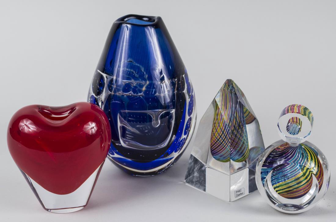 Four Art Glass Table Decorations: All with various internal decoration, comprising an ovoid vase with navy blue abstract decoration, signed, illegibly, two Paul Harrie Zephyr glass articles, a stoppered bottle and an obelisk, signed a