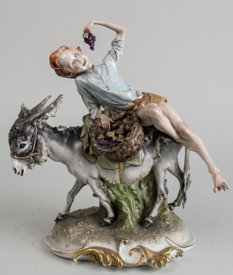 Italian Pottery Figure Group: Depicting a boy riding a donkey and eating from a basket of grapes, signed Giuseppi Cappi and numbered 185. Height 13 1/4 inches. Notice to bidders: Condition reports and additional photographs are pr