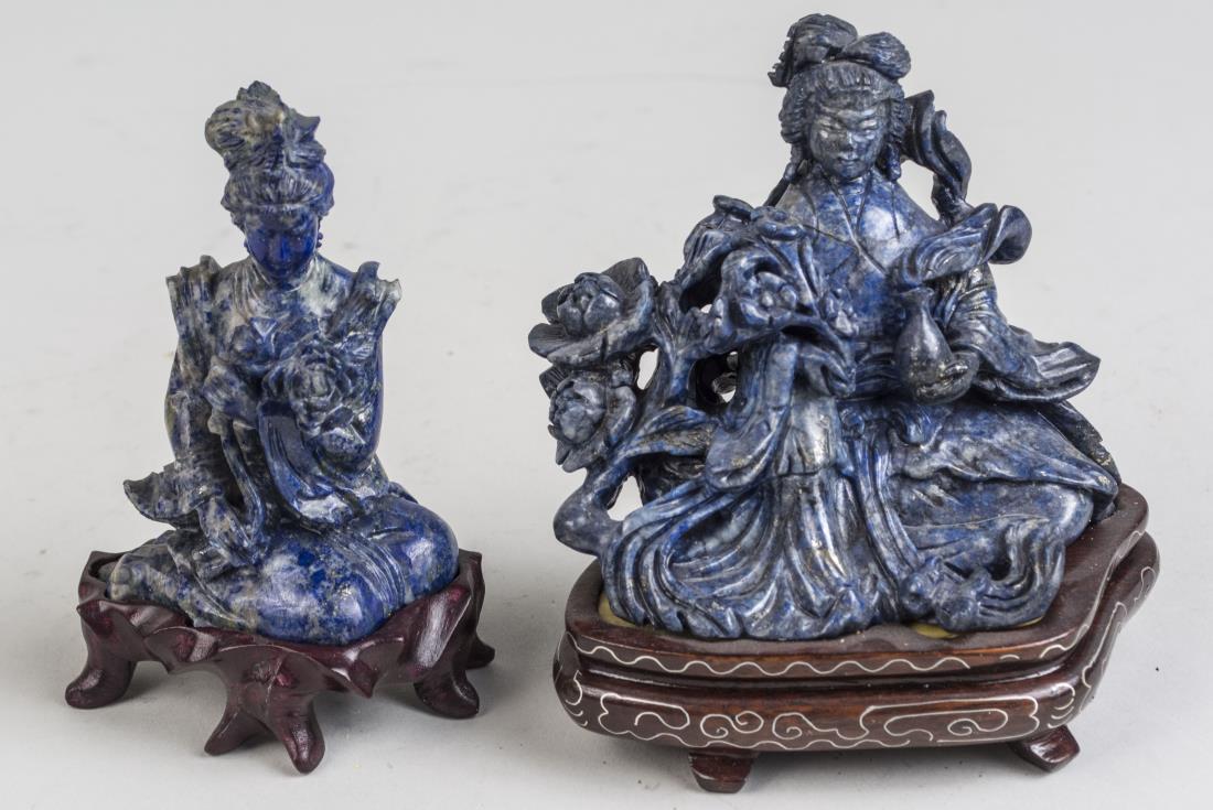Two Chinese Carved Stone Figures: One a kneeling maiden holding flowers, the other a seated maiden holding flowers and a bottle, each on carved wood stand. Taller overall height 4 3/8 inches. Notice to bidders: Condition reports and a