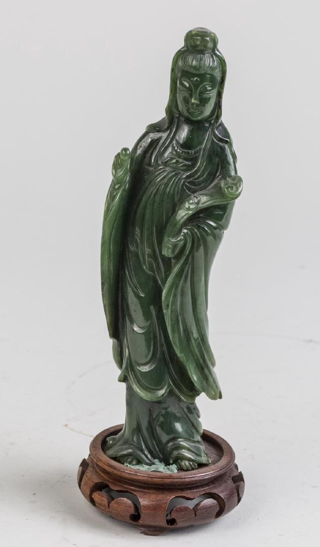 Chinese Carved Jade? Figure: Modeled as a standing maiden holding a ruyi (scepter), on carved wood stand. Overall height 8 inches. Notice to bidders: Condition reports and additional photographs are provided by request as a court