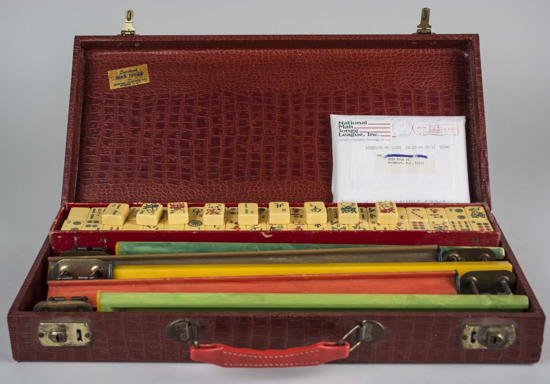 Mahjong Set: In red storage case. Notice to bidders: Condition reports and additional photographs are provided by request as a courtesy to our clients, as such any condition report is only an opinion and should no