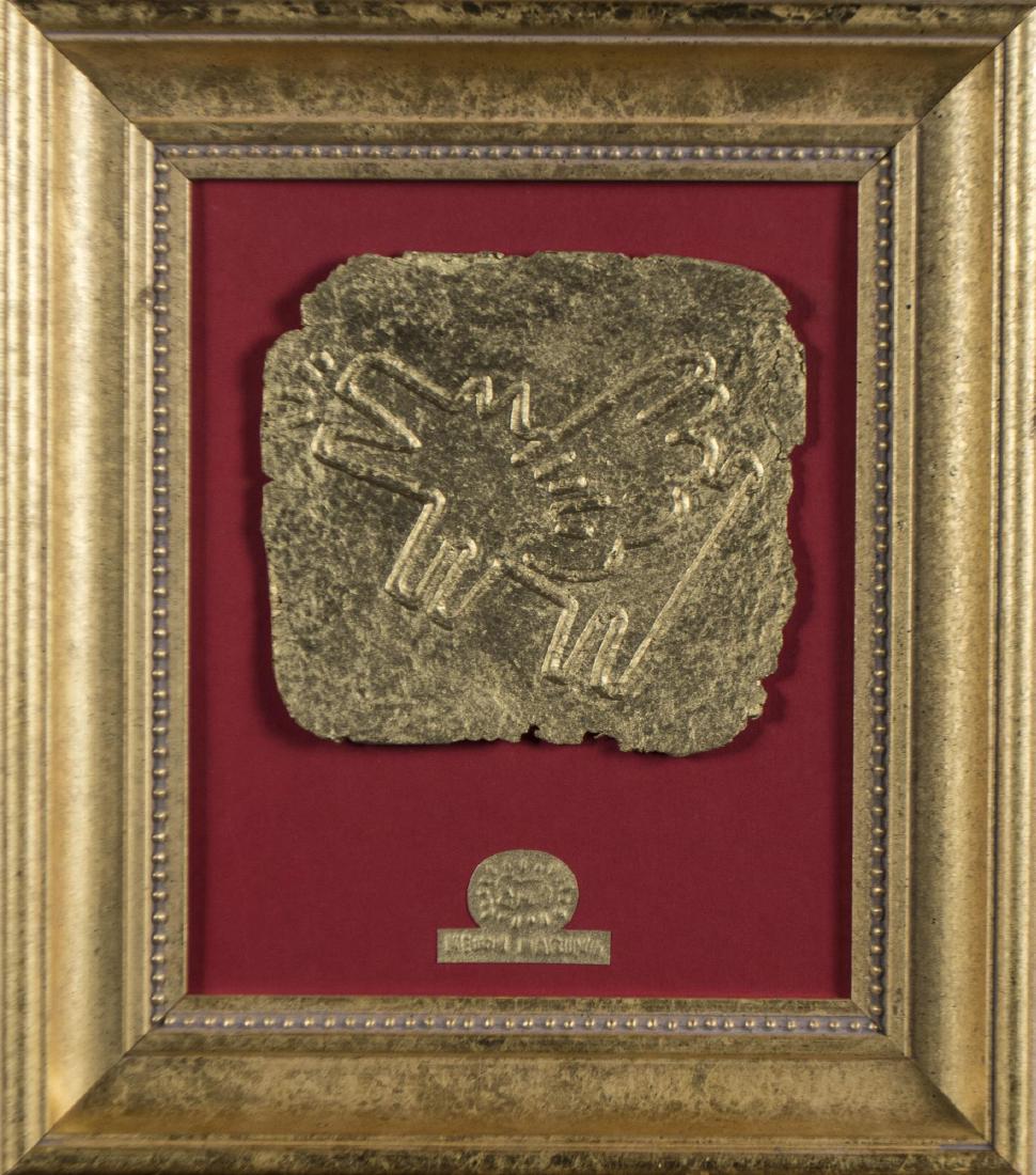 After Keith Haring Fragment: Gold embossed dog. Spray-painted paper mache, 20th century. Sight size 11 x 9 inches. Framed. Notice to bidders: Condition reports and additional photographs are provided by request as a courtesy to o