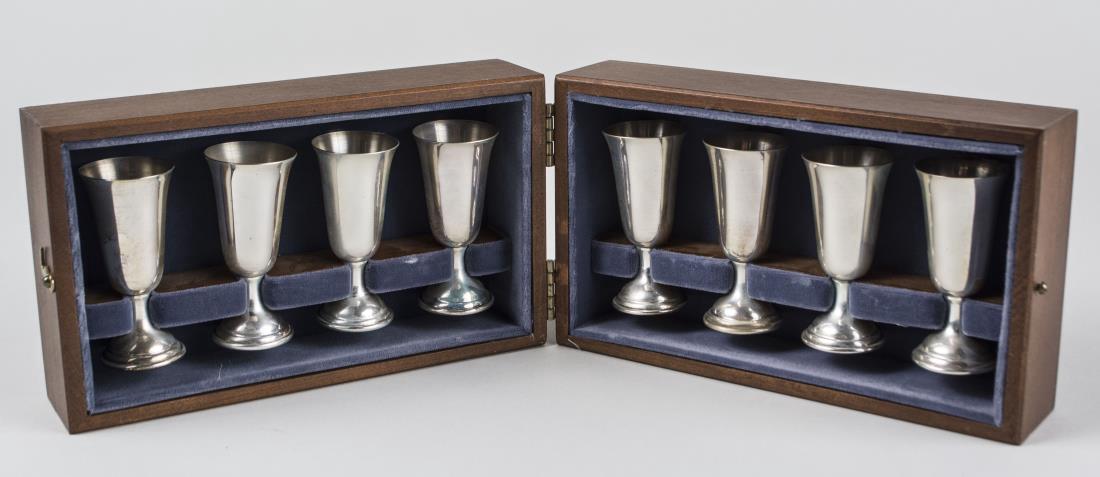 Tuttle Sterling Silver Cordial Set: Eight pedestal cordial goblets in original wood storage box. Height 2 7/8 inches, 140 grams. Notice to bidders: Condition reports and additional photographs are provided by request as a courtesy to ou