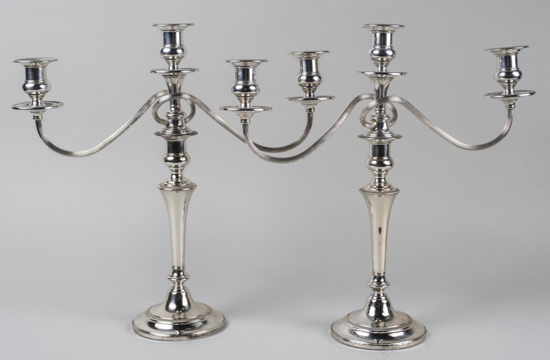 Pair of Fisher Sterling Silver Candelabra: Neoclassical style with scrolled arms and bead decoration. Height 16 1/2 inches, weighted. Notice to bidders: Condition reports and additional photographs are provided by request as a courtesy to our 