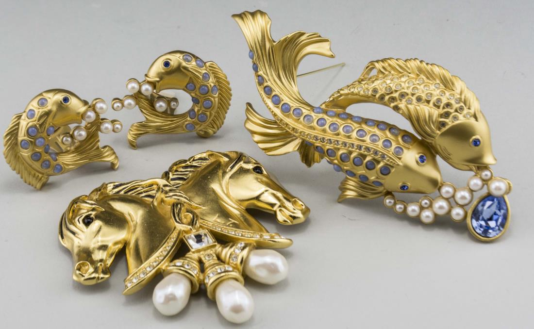 Elizabeth Taylor Jewelry: Comprising a jeweled fish pin and earrings suite and a jeweled horsehead pin, all signed. Notice to bidders: Condition reports and additional photographs are provided by request as a courtesy to our c
