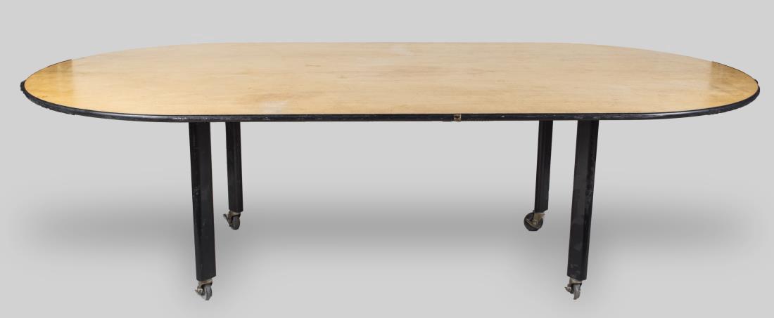 Knoll Table: Oval top on black block legs with casters. Height 28 inches, width 96 inches, depth 48 inches. Provenance: From the Collection of Debra Newhouse Notice to bidders: Condition reports and additional pho