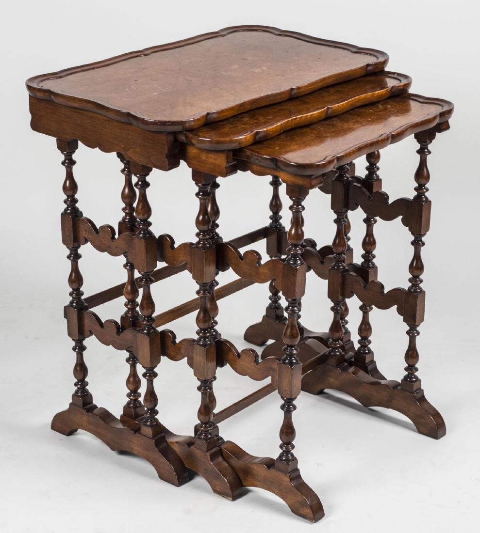 Set of Three Burl Wood Nesting Tables: Shaped rectangular top on turned wood supports. Largest, height 25 inches, width 22 3/4 inches, depth 14 inches. Notice to bidders: Condition reports and additional photographs are provided by request