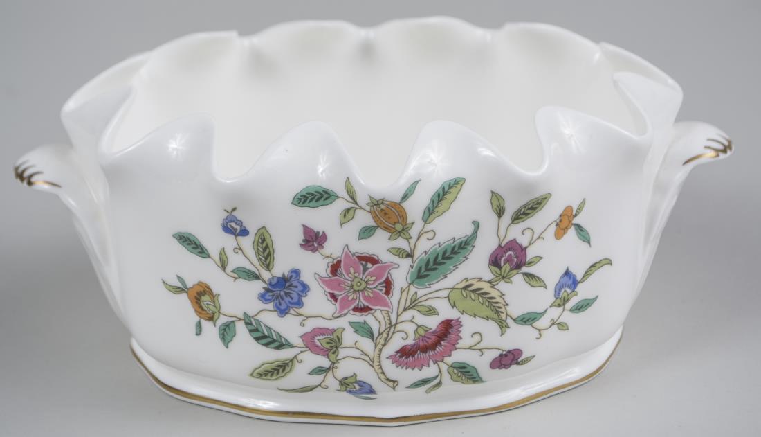 Mintons Porcelain Cachepot: Oval with polychrome floral decoration. Height 3 1/2 inches, width over handles 8 1/2 inches. Notice to bidders: Condition reports and additional photographs are provided by request as a courtesy to o