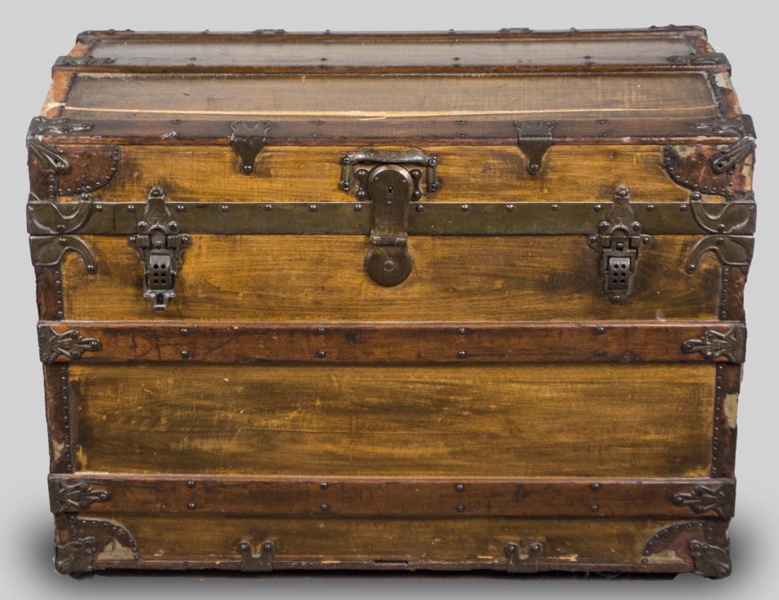 Steamer Trunk: Wood spines and metal hardware. Height 25 inches, width 34 inches, depth 21 inches. Notice to bidders: Condition reports and additional photographs are provided by request as a courtesy to our clients