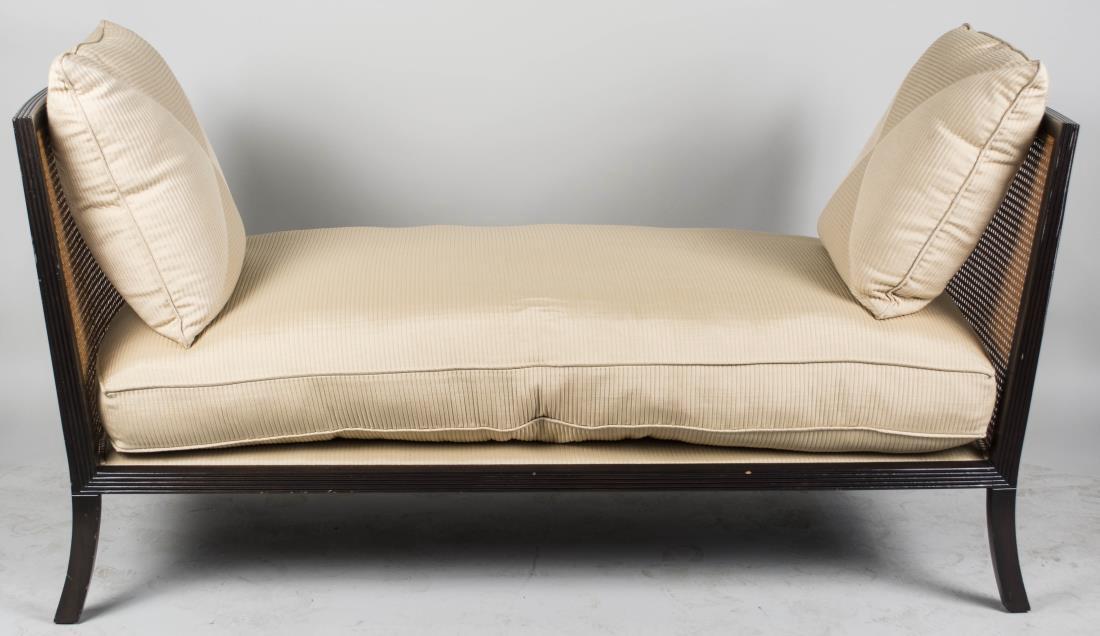 Caned Day Bed: White upholstered cushion seat and two throw pillows. Height 35 inches, width 69 inches, depth 30 inches. Notice to bidders: Condition reports and additional photographs are provided by request as a c
