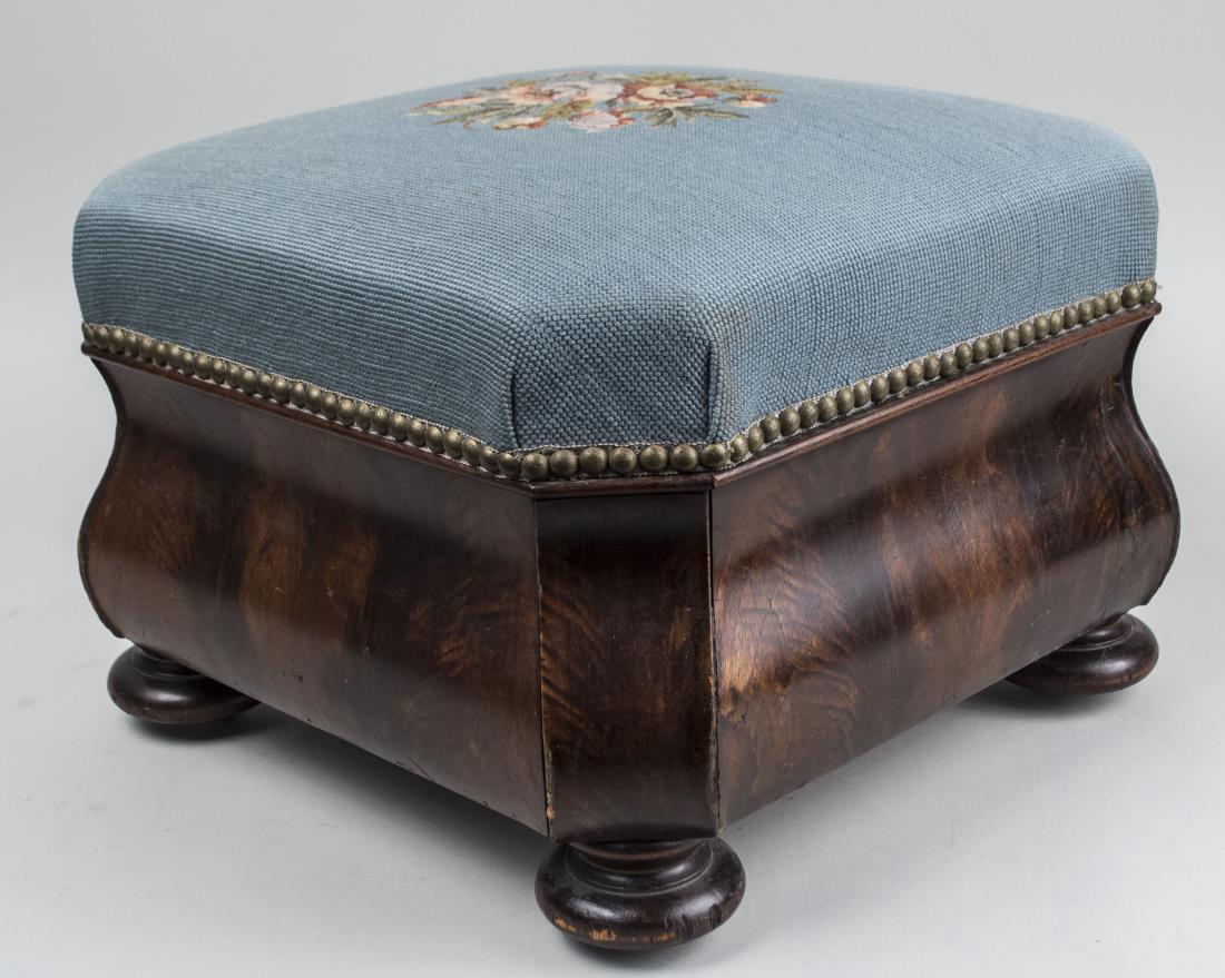 Victorian Mahogany Footstool: Blue upholstery with floral needlework design. Height 12 inches, 17 inches square. Notice to bidders: Condition reports and additional photographs are provided by request as a courtesy to our clients,
