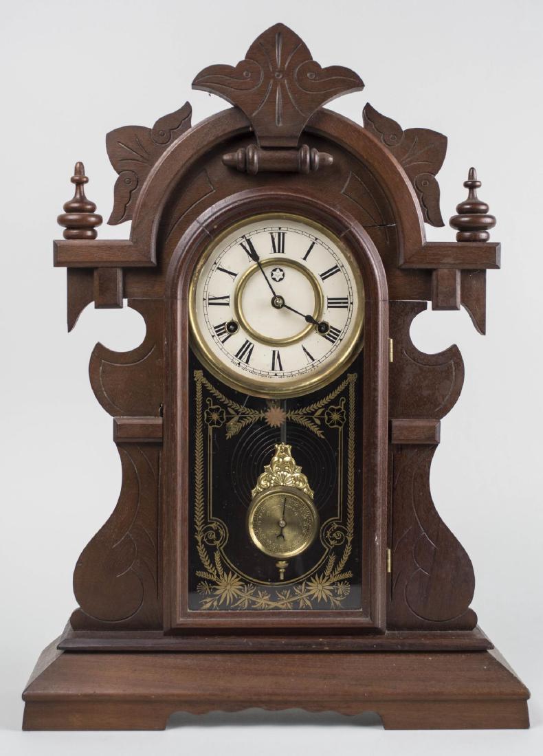 New Haven Clock Co. Shelf Clock: Circa 1890, walnut case, dial with Roman numerals, time and striking on a gong. Height 23 inches. Notice to bidders: Condition reports and additional photographs are provided by request as a courtesy