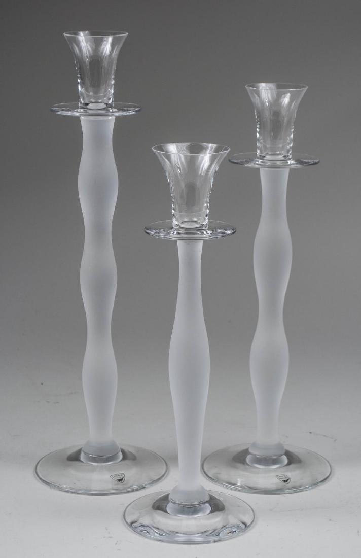 Set of Three Orrefors Celeste Candle Holders: By Anne Nilsson, graduated. Tallest, height 14 1/2 inches. Notice to bidders: Condition reports and additional photographs are provided by request as a courtesy to our clients, as such any condition r