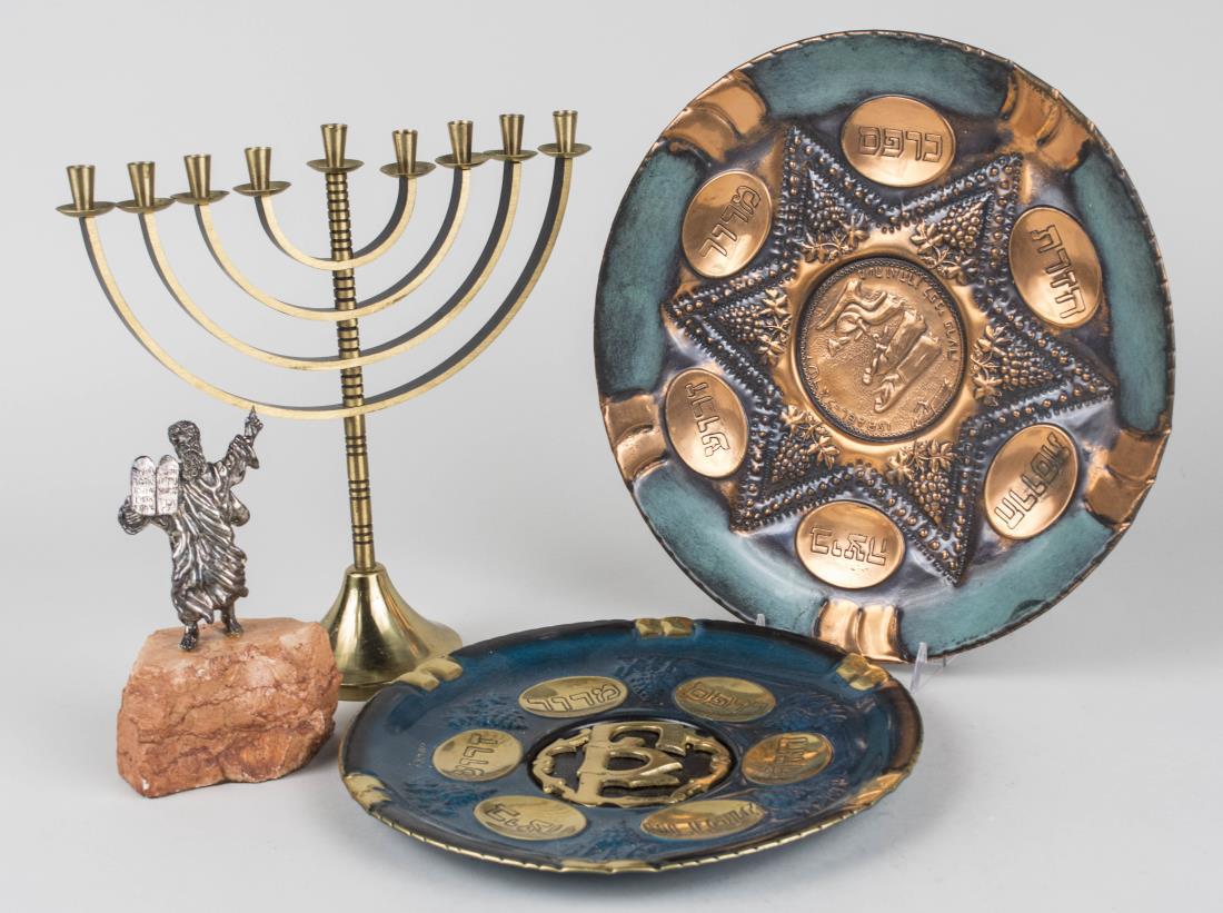 Group of Judaica Articles: Two seder plates, resin filled silver figure of Moses and a brass Menorah. Menorah, height 10 1/4 inches. Notice to bidders: Condition reports and additional photographs are provided by request as a c