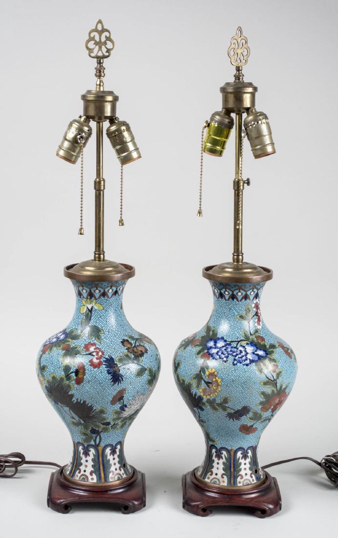 Pair of Cloisonne Lamps: Vase form two light lamps with floral decoration on light blue ground. Base, height 14 1/4 inches. Notice to bidders: Condition reports and additional photographs are provided by request as a courtesy