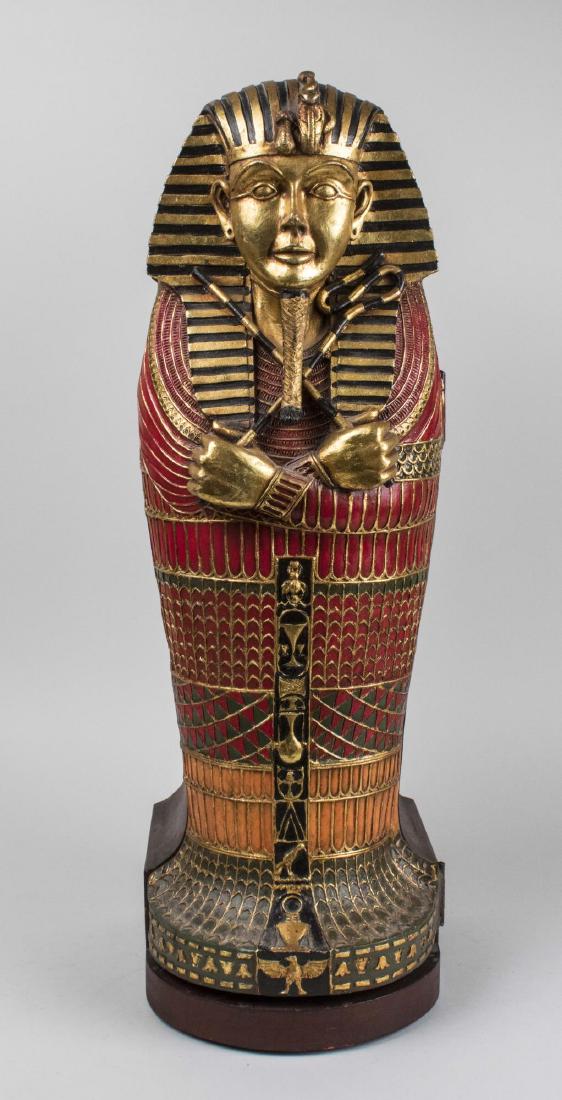 Egyptian King Tut CD Cabinet: In the shape of an Egyptian sarcophagus. Height 27 1/2 inches/ Notice to bidders: Condition reports and additional photographs are provided by request as a courtesy to our clients, as such any conditi