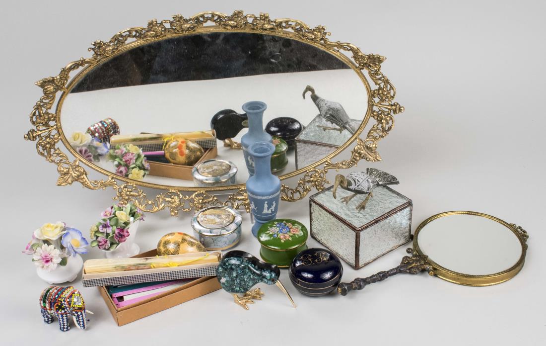 Group of Dresser Decorations: Including an oval mirrored tray, hand mirror, porcelain trinket boxes, Wedgwood style bud vase, etc. Notice to bidders: Condition reports and additional photographs are provided by request as a courte