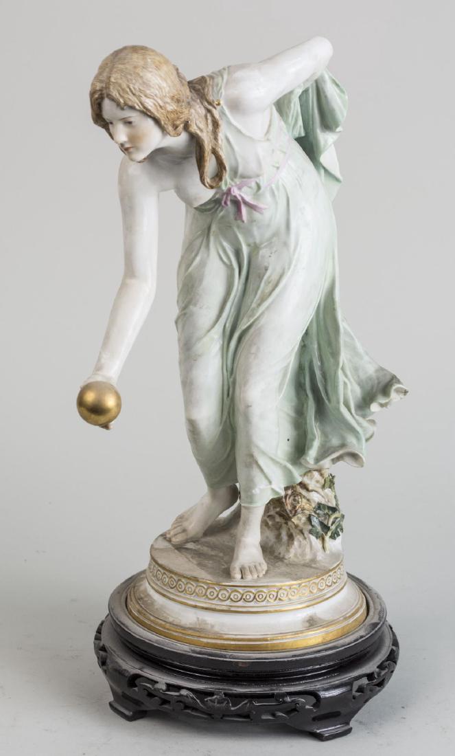Meissen Porcelain Figure: Girl playing bowls by Walter Schott. Height 14 inches. (As is) Notice to bidders: Condition reports and additional photographs are provided by request as a courtesy to our clients, as such any conditi