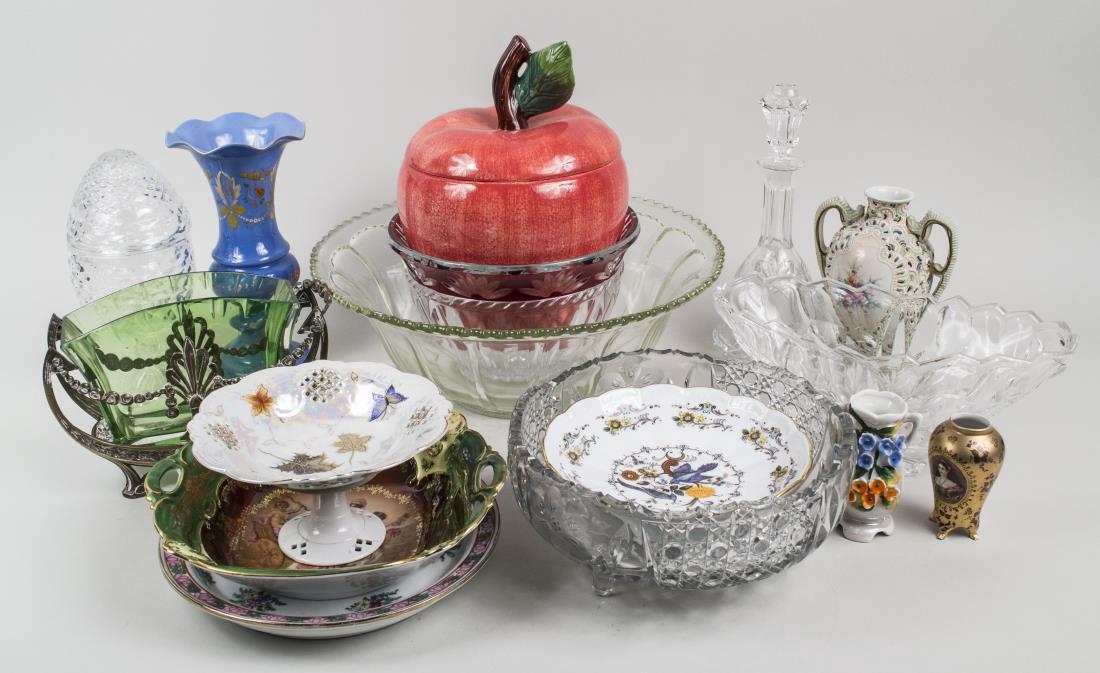 Group of Porcelain and Glass Table Decorations: Various assorted items, including three colorless glass bowls, a colorless glass covered sweetmeat dish, six vases, an apple form cookie jar, a porcelain compote, etc. Blue vase, height 10 1/4 inches.