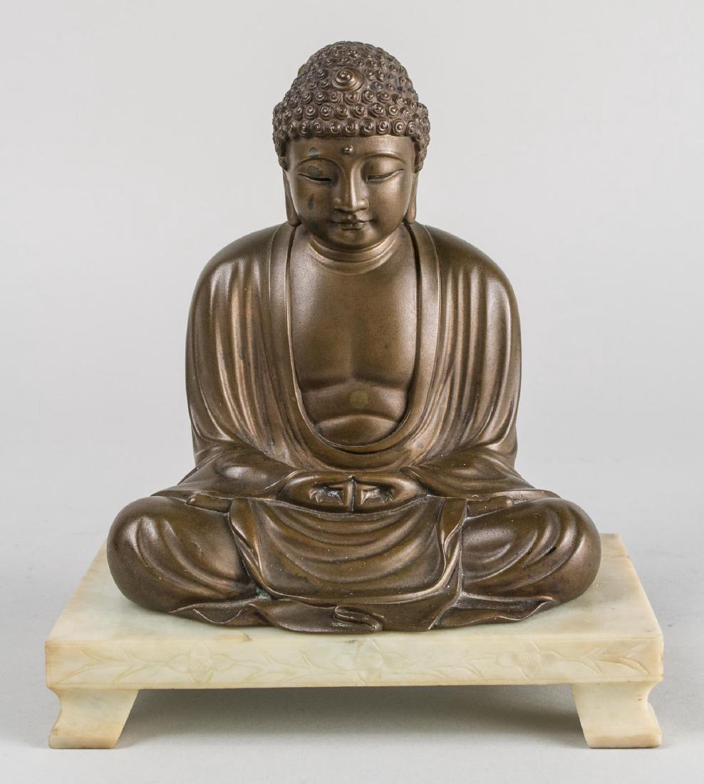 Japanese Bronze Buddha: Figure modeled in seated position on a marble base, signed Seiko. Figure, height 6 1/4 inches. Notice to bidders: Condition reports and additional photographs are provided by request as a courtesy to 