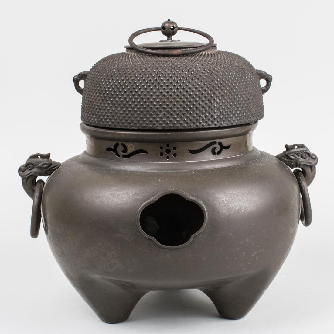 Japanese Furogama Tea Kettle and Brazier: Consisting of a two handled bronze brazier and cast iron kettle. Height 13 1/2 inches Notice to bidders: Condition reports and additional photographs are provided by request as a courtesy to our clien