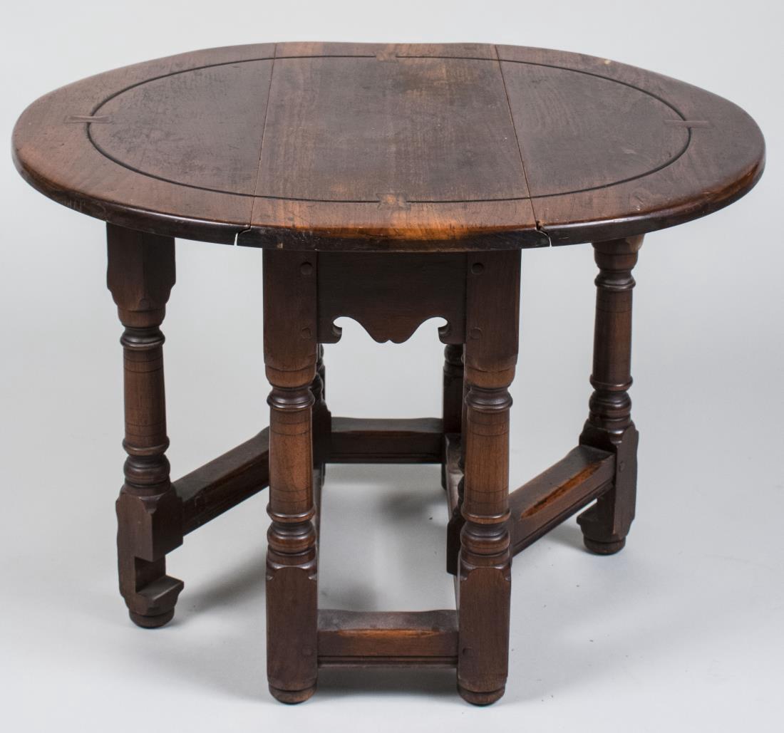 Drop Leaf Gate Leg Table: Circular top on turned legs. Height 19 inches, width 24 inches, depth 11 inches. Notice to bidders: Condition reports and additional photographs are provided by request as a courtesy to our clients, a