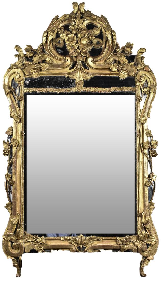 Gilt Wood Mirror: Rococo style with flower, scroll and fruting vine decoration. Height 64 inches, width 36 inches. Notice to bidders: Condition reports and additional photographs are provided by request as a courtesy t