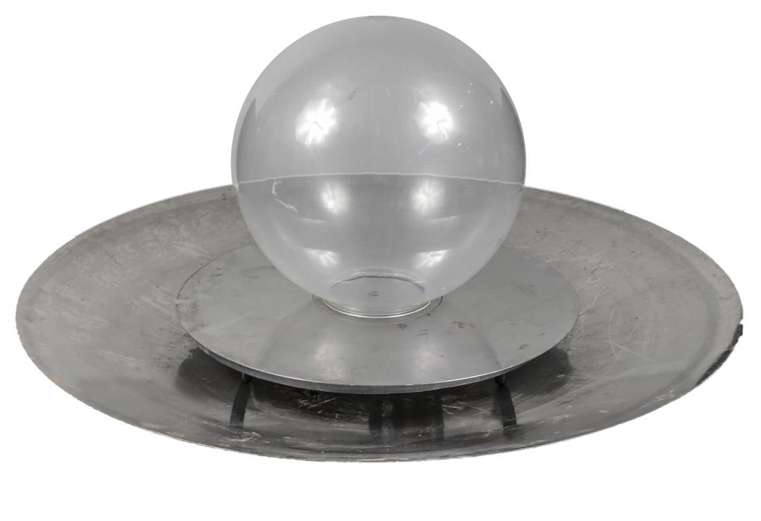 Allison Amour Aqua Lens Modern Fountain: Shallow dish base supporting an acrylic globular central ball. Height 32 inches, diameter 60 inches. Notice to bidders: Condition reports and additional photographs are provided by request as a courte