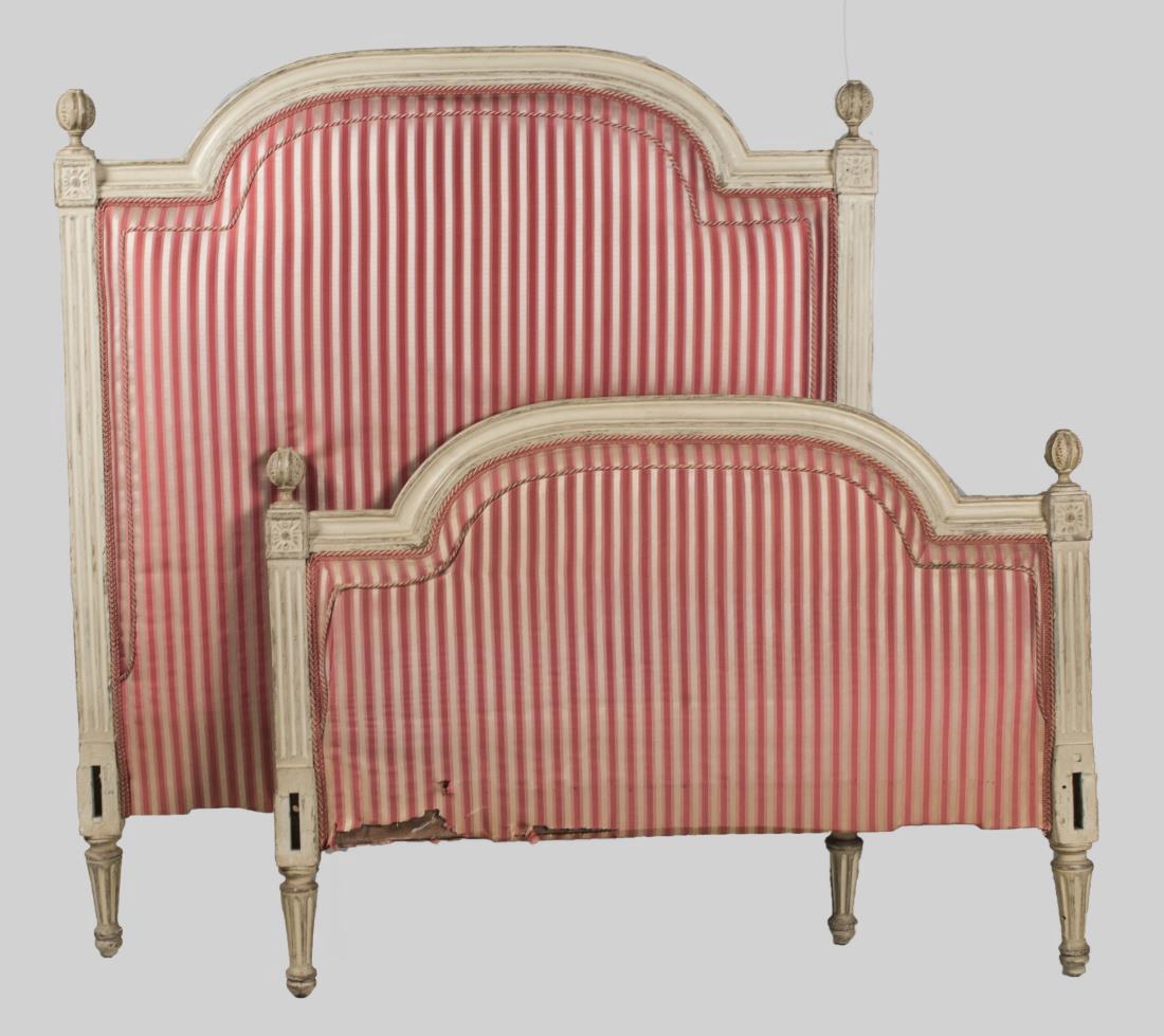 Louis XVI Style Upholstered Bedstead: Headboard and footboard with arched top, red and white striped upholstery, and flanked by fluted pilasters with ball finials, all on tapered fluted legs. Head board, height 50 inches, width 45 inches.