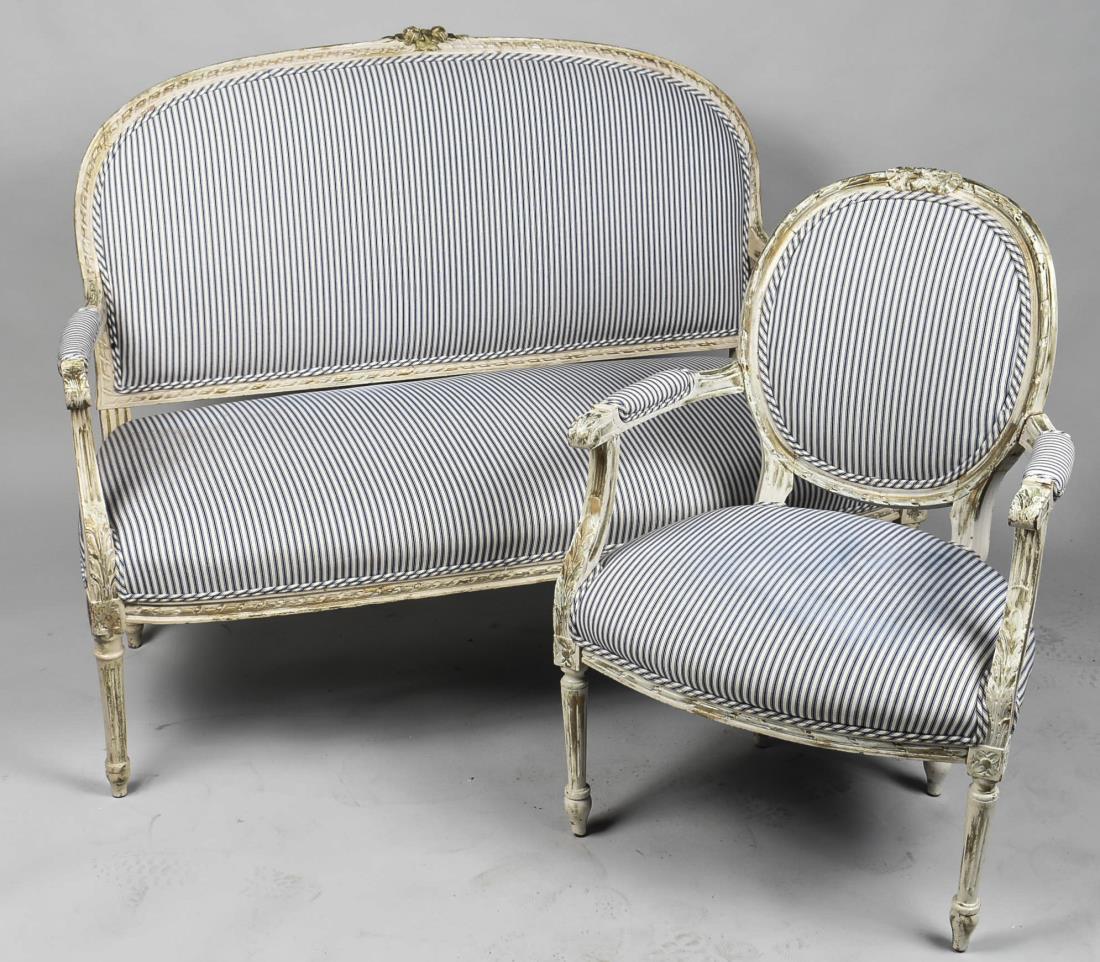 Louis XVI Style Painted Furniture Suite: White painted fauteuil and canape, with mattress ticking upholstery, each with oval back, padded arms and tapered fluted legs. Canape, height 40 inches, length 54 inches, depth 27 inches. Notice to bi