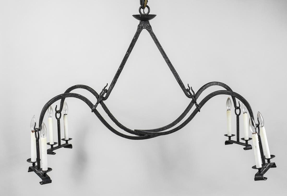 Cast Iron Chandelier: Four scrolled arms each ending in a two light candelabrum. Height 30 inches, width 42 inches, depth 36 inches. Notice to bidders: Condition reports and additional photographs are provided by request a