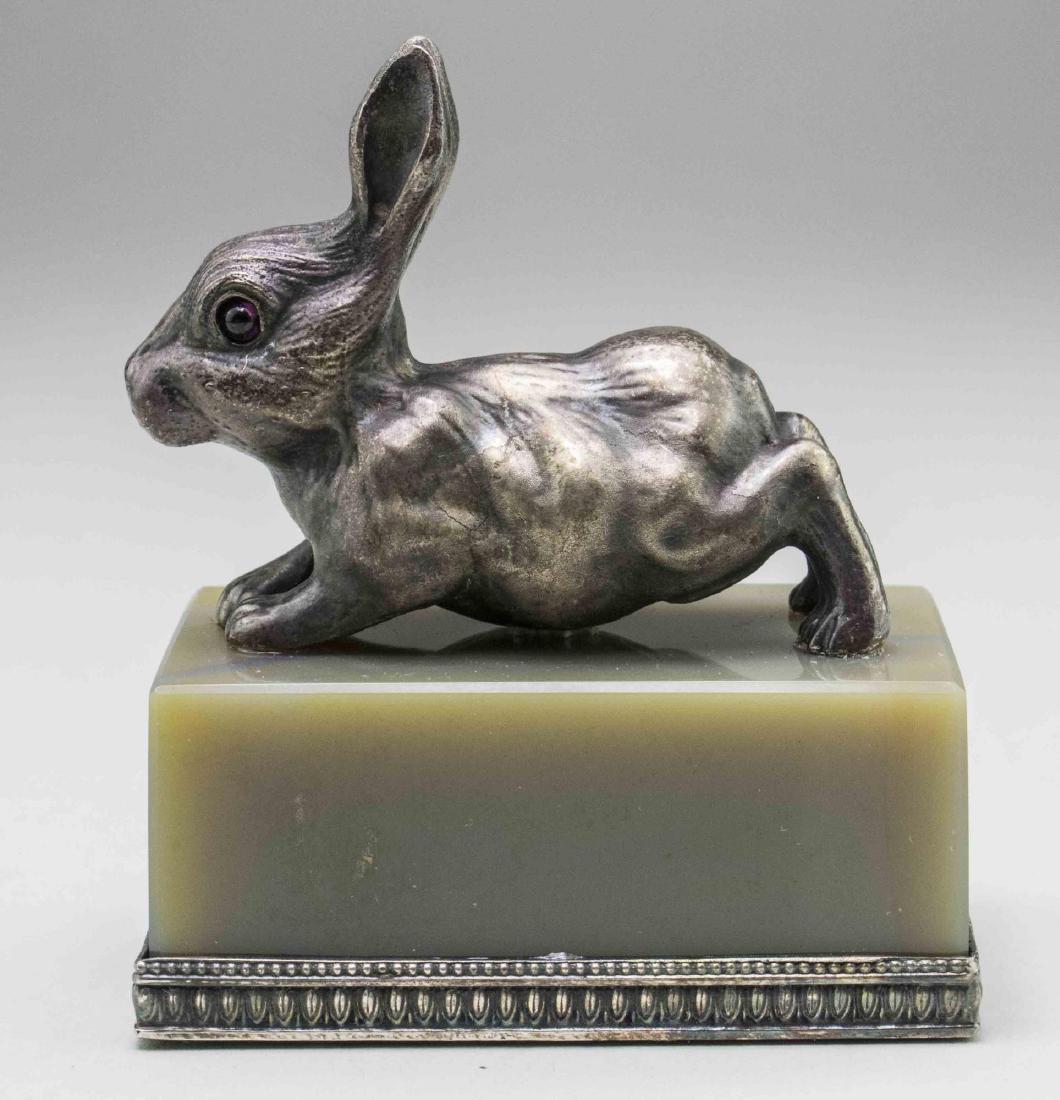 Russian Silver Rabbit Figure *: In the manner of Faberge, with garnet eyes on an agate base. Height overall, 3 inches. Notice to bidders: Condition reports and additional photographs are provided by request as a courtesy to our clie