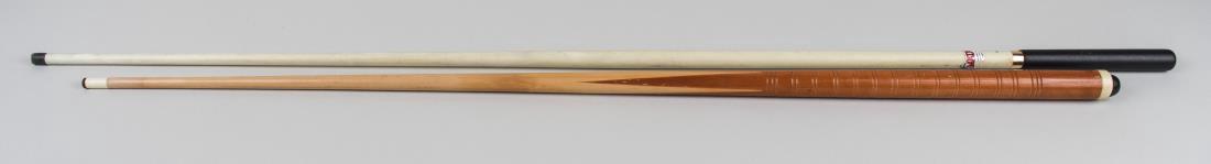 Two Masse Pool Cues: One a wood cue, the other a fiberglass cue with rubberized grip. Notice to bidders: Condition reports and additional photographs are provided by request as a courtesy to our clients, as such any condi