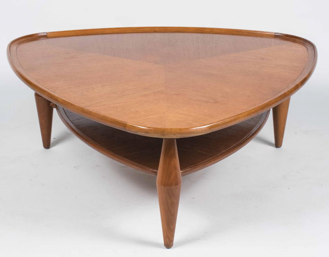 Danish Style Coffee Table: Shaped triangular dish top table on turned legs joined by a lower shelf. Height 15 1/2 inches, width 39 1/2 inches, depth 39 inches. Notice to bidders: Condition reports and additional photographs are