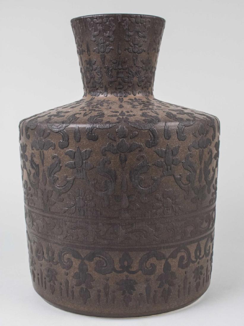 Ceramic Damask Pattern Vase: Tapered cylindrical neck, spreading shoulders and cylindrical body, allover raised decoration. Height 16 inches. Provenance: Estate of Sandy Gallin Notice to bidders: Condition reports and additional 