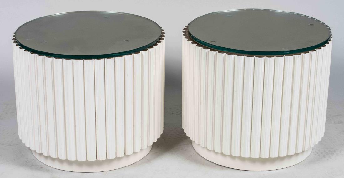 Pair of White and Gold Side Tables: Cylindrical ribbed tables, with separate glass top. Height 16 inches, diameter 20 inches. Notice to bidders: Condition reports and additional photographs are provided by request as a courtesy to our c