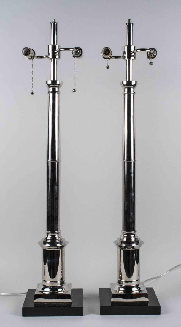 Pair of Chrome Lamps: Two light chromed columnar lamps on square black stone bases. Height 40 inches. Notice to bidders: Condition reports and additional photographs are provided by request as a courtesy to our clients, as