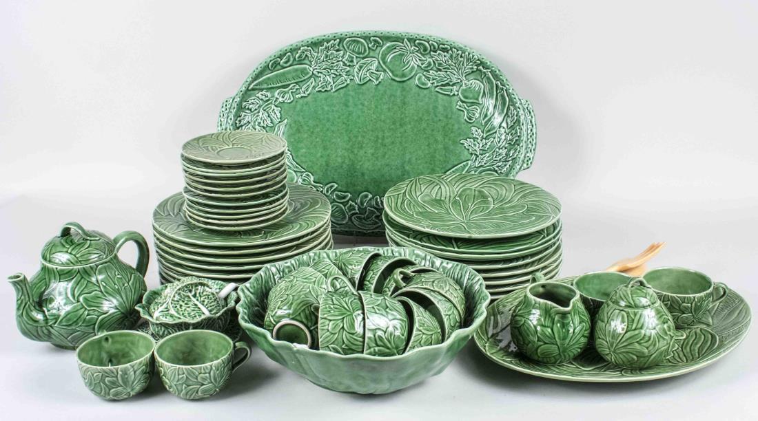 Green Pottery Dinner Service: Including two platters, eighteen plates, fourteen cups and saucers, teapot, cream and sugar, etc. Plates, diameter 10 1/2 inches. Notice to bidders: Condition reports and additional photographs are pr