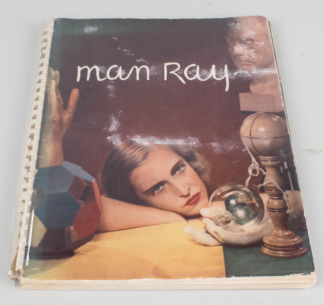 Photographs by Man Ray 1920 Paris 1934: Book titled 'Photographs by Man Ray 1920 Paris 1934.' Monochromes by Neogravues Company, printed 1934. Published by James Thrall Soby, Hartford, CT. Spiral bound with plastic protector. Size 12.5 x 10