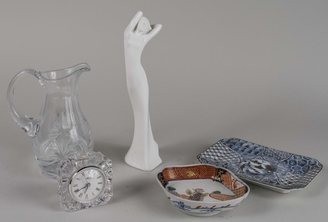 Miscellaneous Group Table Decorations: White porcelain female figure, Bohemian cut glass pitcher, desk clock and two porcelain dishes. Figure, height 12 inches. Notice to bidders: Condition reports and additional photographs are provided b