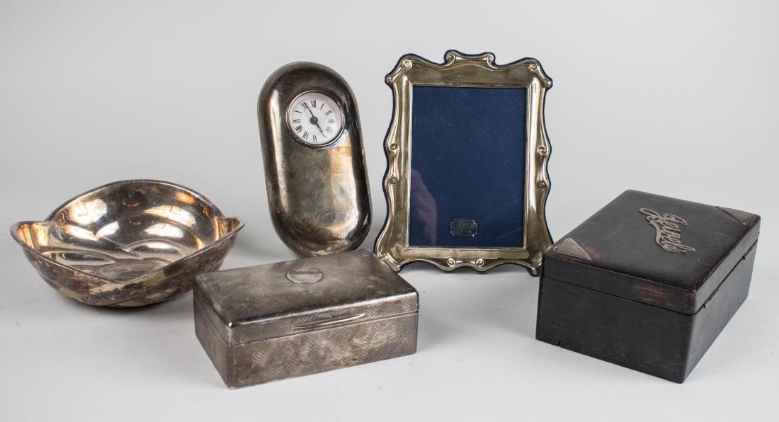 Group of Silver and Silver Plated Articles: Two English boxes, an English silver picture frame, a silver desk clock and a silver plated bowl. Clock, height 7 inches. Notice to bidders: Condition reports and additional photographs are provided b