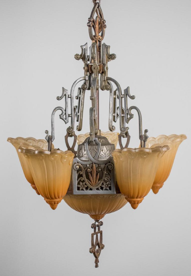 Gothic Revival Style Chandelier: Five scrolled arms with amber frosted glass shades. Height 15 1/2 inches. Notice to bidders: Condition reports and additional photographs are provided by request as a courtesy to our clients, as such 