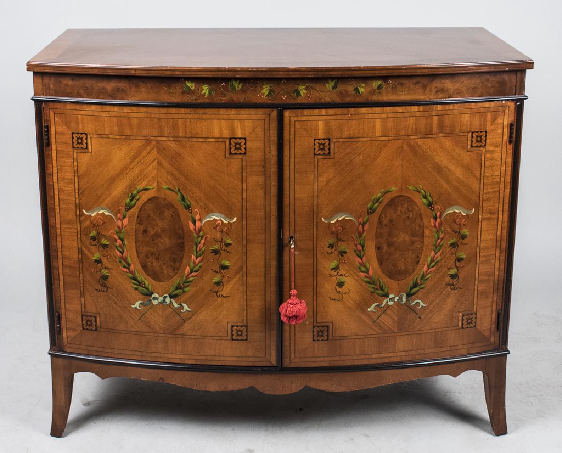 Edwardian Style Two Door Cabinet: Bow front top over two conforming polychrome painted doors above a shaped apron and splayed front legs. Height 36 inches, width 42 inches, depth 22 inches. Notice to bidders: Condition reports and add