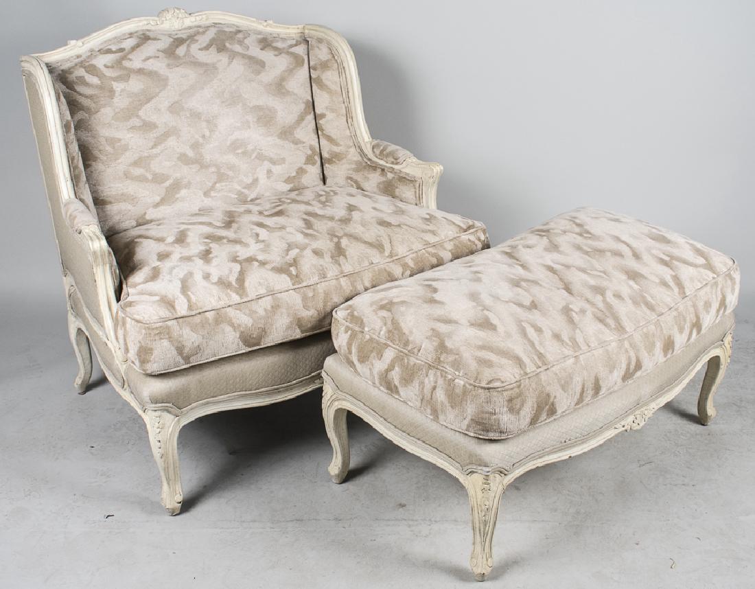 Louis XV Style Painted Marquise with Ottoman: White painted chair with slightly arched crest rail, upholstered back with wings, cushion seat and short cabriole legs, with matching ottoman. Height 37 inches, width 35 inches, depth 29 inches. Notic