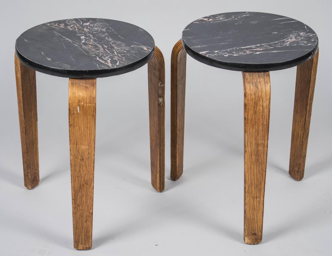 Pair of Alvar Aalto Stacking Tables: Each with a circular faux grey-veined black marble top. Height 20 inches, diameter 15 inches. Notice to bidders: Condition reports and additional photographs are provided by request as a courtesy to o
