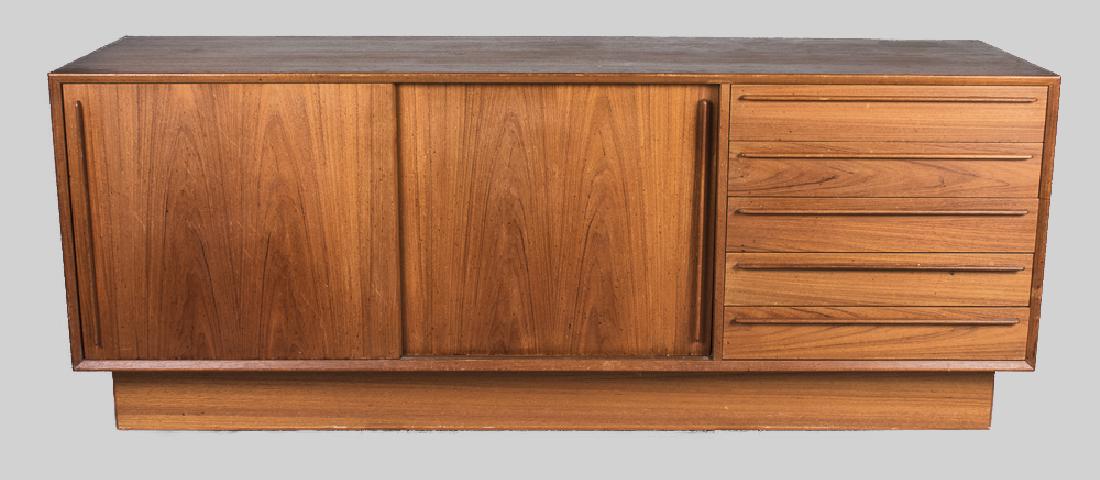 Danish Modern Sideboard: Rectangular top over an asymmetrical design of two sliding doors and a bank of five drawers. Height 28 inches, width 71 inches, depth 20 inches. Notice to bidders: Condition reports and additional pho