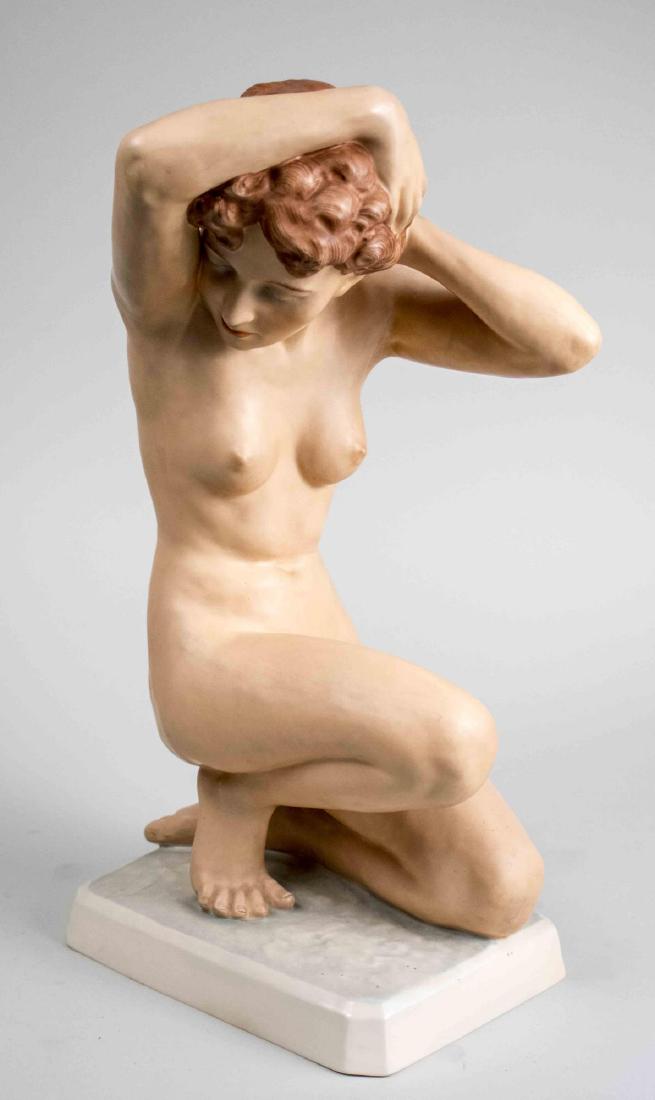 Royal Dux Porcelain Figure: Modelled as a young woman bathing. Height 19 1/2 inches. Notice to bidders: Condition reports and additional photographs are provided by request as a courtesy to our clients, as such any condition rep