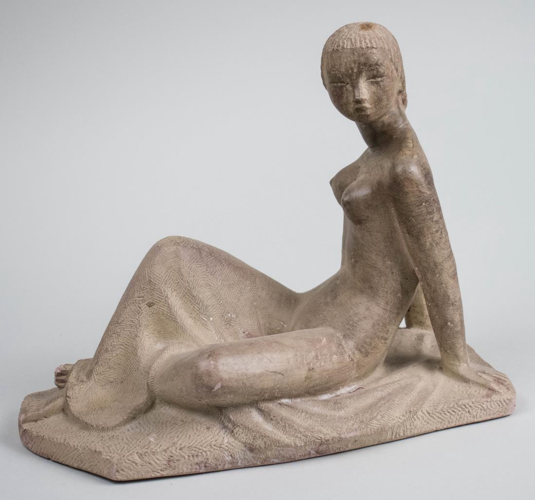 Ceramic Figure: Young woman in reclining position. Height 8 inches. Notice to bidders: Condition reports and additional photographs are provided by request as a courtesy to our clients, as such any condition report i