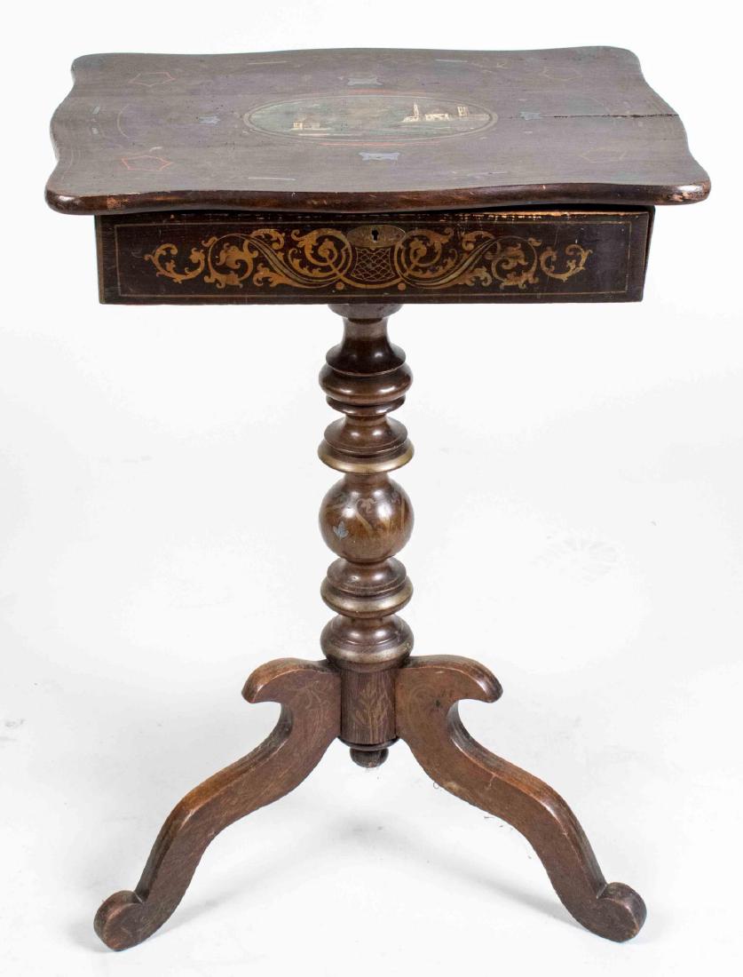 Victorian Black Painted Sewing Table: Late 19th century, shaped rectangular lift top decorated with a landscape scene, on a turned support with tripod base. Height 29 inches, width 20 inches, depth 14 1/2 inches. Notice to bidders: Condit